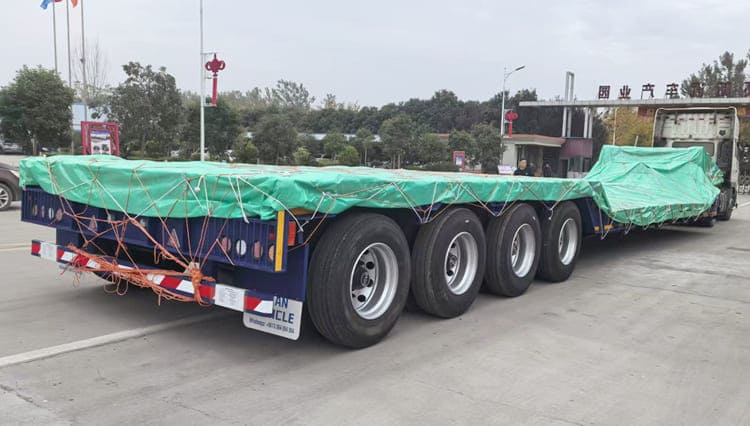 Packing of Gooseneck Lowboy Trailers​ To ensure the 100 ton gooseneck lowboy trailers arrive in Rwanda intact, multi-layer protection measures are implemented before shipment: High-elastic foam blocks are precisely placed to fill gaps between protruding components like connecting parts, landing gear and suspension components and the shipping container, forming a buffer that eliminates shaking-induced damage to delicate parts. A thick waterproof and moisture-proof film fully covers the entire trailer surface, tightly isolating external rainwater and humid air—this is especially critical for Rwanda’s shipping routes and storage environments, effectively keeping the gooseneck lowboy trailer dry and rust-free before it’s put into use.